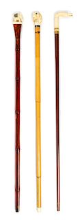 Three Continental Carved Zoomorphic Walking Sticks Length of longest 36 inches.