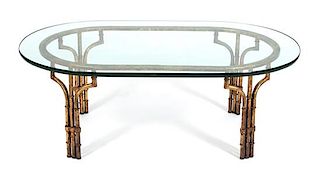 A Modern Gilt Metal Faux-Bamboo Glass Top Table Height 16 1/4 x width 44 x depth 28 inches.