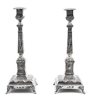 A Pair of Russian Silver Candlesticks, Russia, Late 19th Century, with faceted stem, stepped base, molded with classical motifs