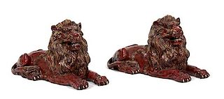 A Pair of Italian Glazed Recumbent Lions Length 30 inches.
