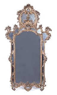 A Louis XV Style Carved Giltwood Mirror Height 77 x width 41 inches.