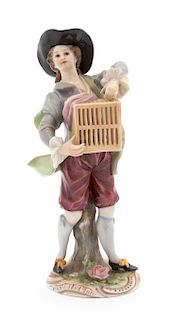 A Ludwigsburg Porcelain Figure of a Boy with Caged Bird Height 6 1/2 inches.