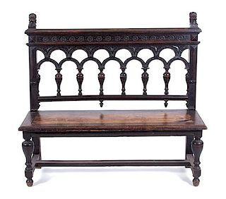 A Gothic Revival Style Bench Height 46 x width 50 x depth 15 inches.