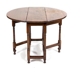 An English Jacobean Style Oak Gate Leg Table Height 27 x width 38 x depth 12 1/2 inches (closed).