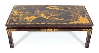 A Chinoiserie Decorated Black and Gilt Lacquered Low Table Height 15 1/2 x width 44 1/2 x depth 22 1/2 inches.
