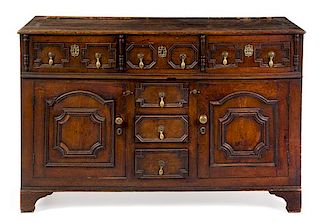A Charles II Style Oak Cabinet Height 36 x width 55 3/4 x depth 19 1/4 inches.