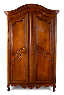 A Louis XV Provincial Carved Fruitwood Armoire Height 110 x width 65 x depth 25 inches.