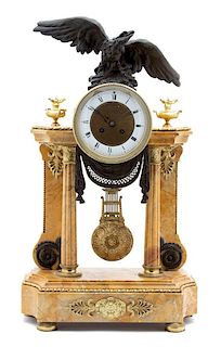 A Louis XVI Style Parcel-Gilt, Patinated Bronze and Marble Portico Clock Height 23 x width 13 1/4 x depth 5 3/4 inches.