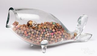 Glass whale filled with clay marbles