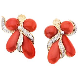 A coral and diamond 18K yellow gold pair of earrings.