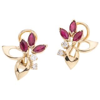 A ruby and diamond 14K yellow gold pair of earrings.