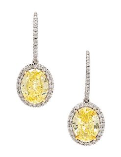 A Pair of Platinum, Fancy Intense Yellow Diamond and Diamond Earrings, 3.70 dwts.