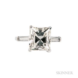 Platinum and Diamond Solitaire, prong-set with a fancy-cut diamond weighing 3.77 cts., flanked by baguettes, size 5 3/4.