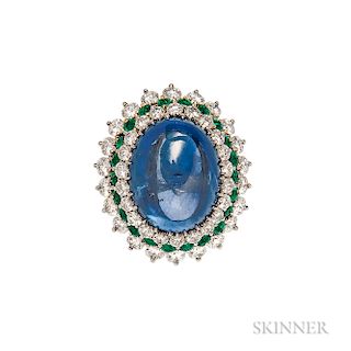 Sapphire, Emerald, and Diamond Ring, set with a large oval cabochon sapphire measuring approx. 19.40 x 15.50 mm, framed by circular-cut