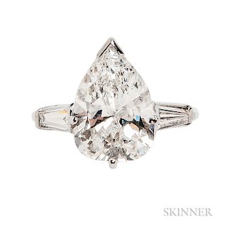 Platinum and Diamond Solitaire, prong-set with a pear-shape diamond weighing 4.24 cts., flanked by tapered baguettes, size 4 3/4. Note: