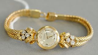 Jaeger Coultre 18 karat yellow gold womens wristwatch with 18 karat yellow gold band, set with six diamonds, back wind, total weight...