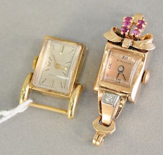 Two 14 karat gold ladies watch, no bands, one Movado. 21.6 grams total weight