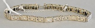 10 karat white gold filigree bracelet set with five small diamonds. 8.4 grams