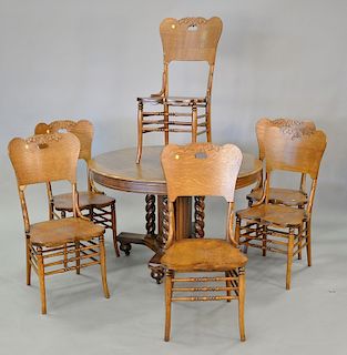 Round oak Victorian table and six oak chairs. ht. 30 in., dia. 48