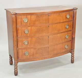 Four drawer Sheraton bow front chest with turret corners, circa 1830.