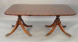 Custom mahogany two part dining table on pedestal bases with two 24 inch leaves and pads. ht. 29 1/2 in., top closed: 46" x 71", top...