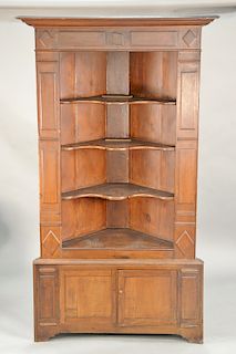 Primitive corner cupboard in two parts with raised panels and two doors. ht. 85 in., wd. 51 in., dp. 24 in.