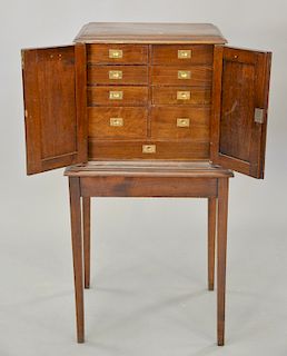 Walnut humidor cabinet with two doors, nine fitted drawer interior with porcelain bottoms and small back door, all on stand. ht. 40 ...