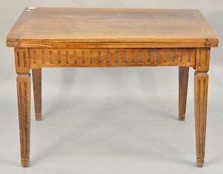 Walnut folding table having hinged top on fluted legs. 
Provenance: Estate from Park Avenue, New York