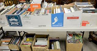 Approximately fifty-four boxes of books on top and below two tables, some leather bound, catalogs, coffee table books, etc.