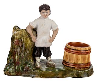 A RUSSIAN PORCELAIN INKWELL IN THE FORM OF A BOY LEANING ON A TREE STUMP, KUZNETSOV PORCELAIN FACTORY, MOSCOW, 19TH CENTURY