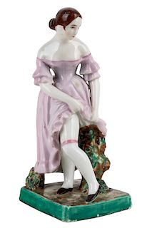 A RUSSIAN PORCELAIN FIGURE OF A YOUNG WOMAN IN STOCKINGS, TEREKHOV AND KISSELEV MANUFACTORY, PERM