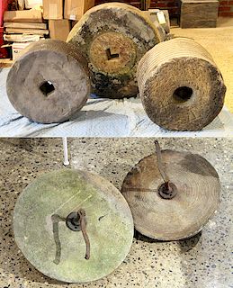 GROUP OF FIVE CARVED STONE MILLSTONES