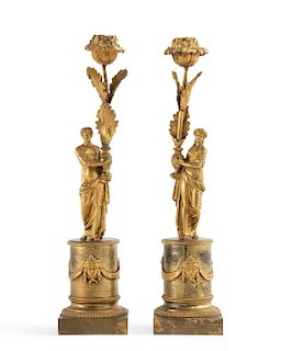 A pair of Empire gilt bronze figural candlesticks