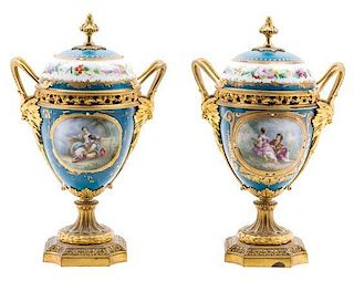 * A Pair of Sevres Style Gilt Bronze Mounted Porcelain Urns Height 11 inches.