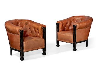 A pair of tufted leather library armchairs