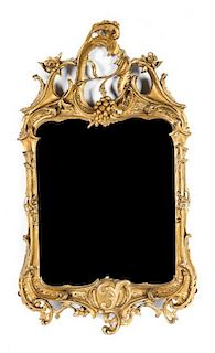 A Rococo Giltwood Mirror Height 32 1/2 x width 19 1/4 inches.