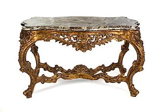 A Louis XV Style Giltwood Center Table Height 34 1/2 x width 56 x depth 37 inches.