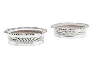 A pair of George IV sterling silver wine coasters