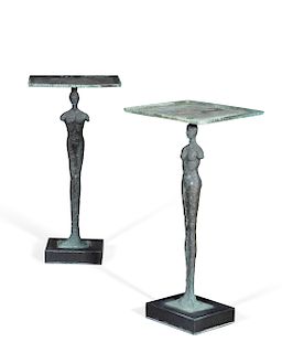 A pair of bronze and granite figural side tables