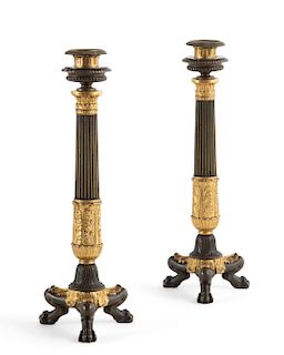 A pair of French bronze candlesticks
