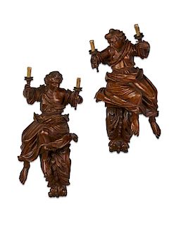 Pair of stained pine figural wall lights, 18th c