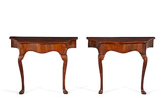 A pair of George II style yew & walnut consoles