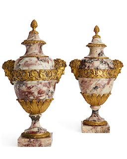 A pair of Louis XVI style bronze and marble urns