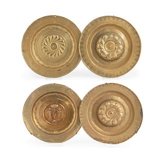 Four Continental brass alms dishes, 17th century