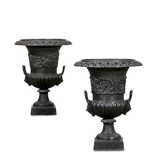 A pair of Neoclassical style cast iron urns