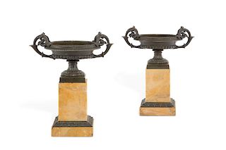 A pair of Empire style bronze and marble urns