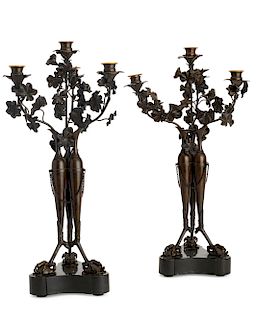 A pair of French bronze four light candelabra
