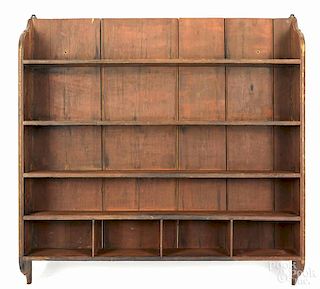 New England pine hanging shelf, early/mid 19th c., retaining its original red/brown stained surface