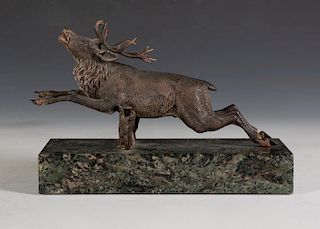 A Cold Painted Bronze Figure of a Stag Jumping a Fence,