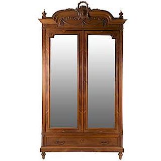 Armario. Francia Siglo XX. En talla de madera 2 puertas abatibles con espejo de luna rectangular biselada,cajón con tiradores de metal.